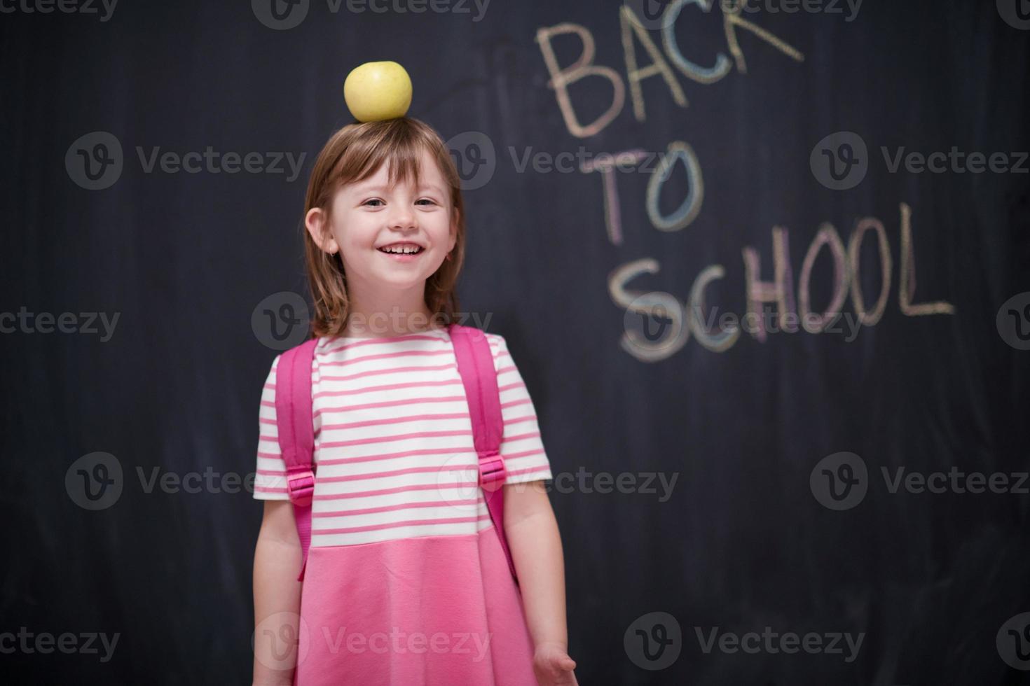 child holding apple on head photo
