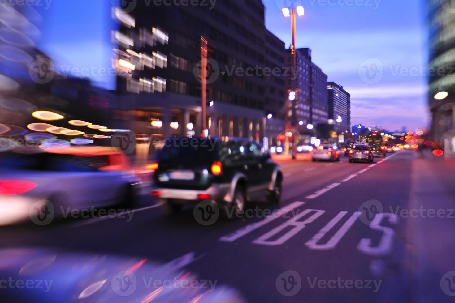 City night with cars motion blurred light in busy street photo