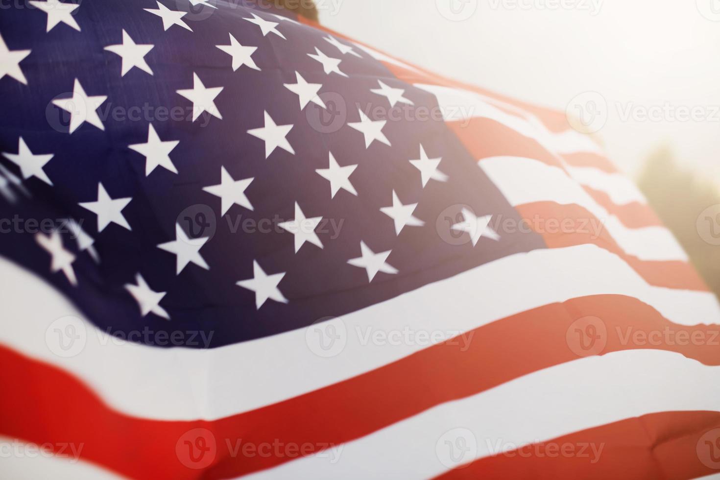 Veterans Day Flag Of The United States Of America. American flag flying on the background of the setting sun in nature. photo