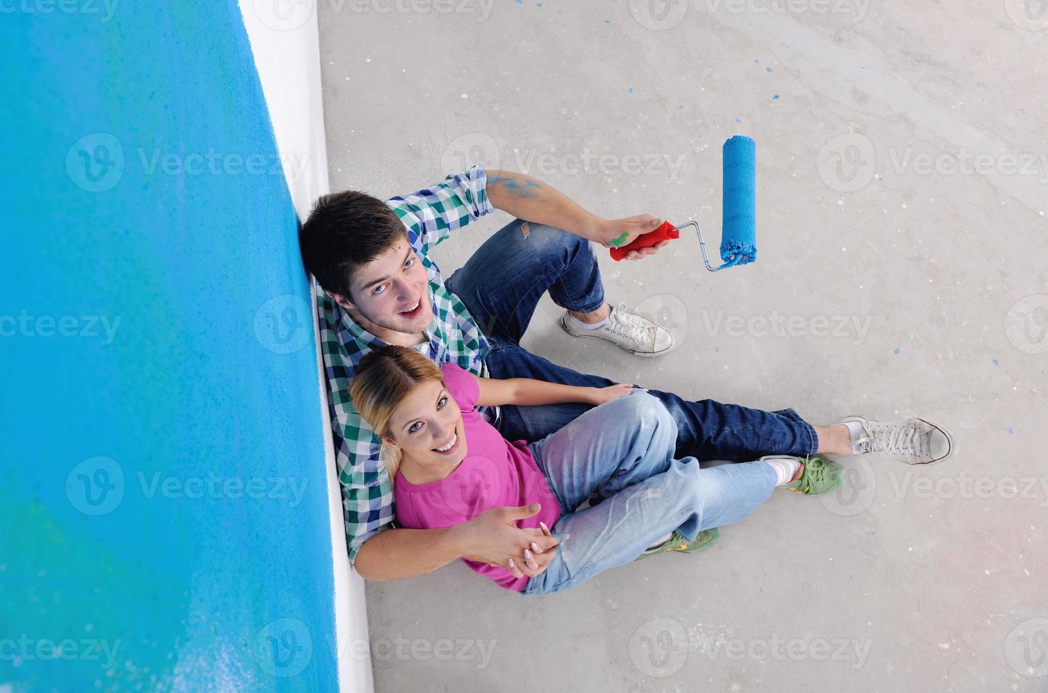 happy young cople relaxing after painting in new home photo
