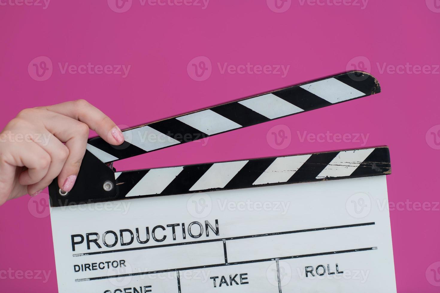 movie clapper on pink background photo