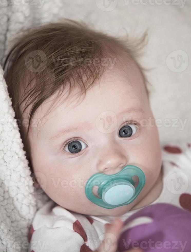 cute little baby playing with hands and smiling photo