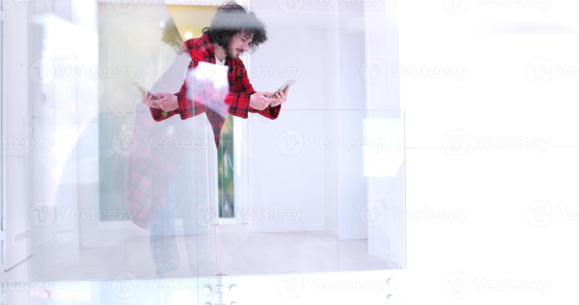 young man using a tablet at home photo