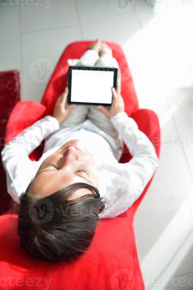 young woman watching tv at home photo