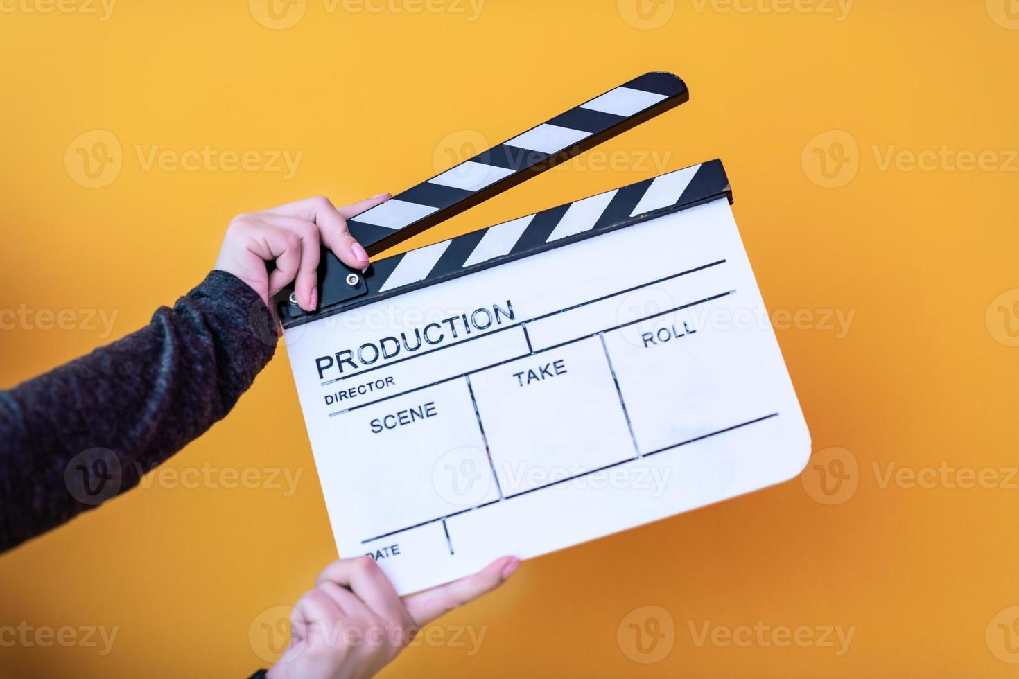 movie clapper isolated on yellow background photo