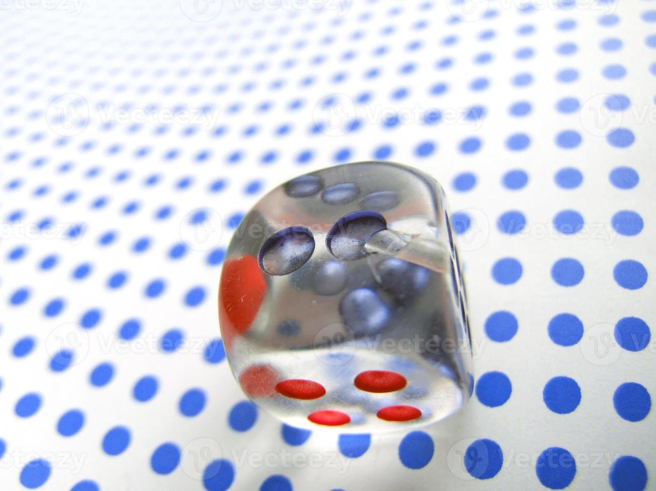gamblig dice on blue dotted background photo