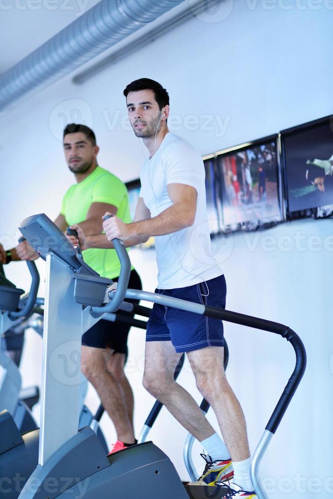 Group of people running on treadmills photo