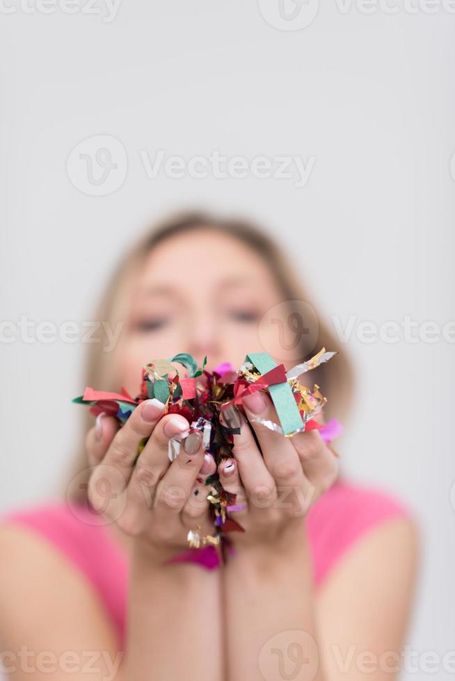 woman blowing confetti in the air photo