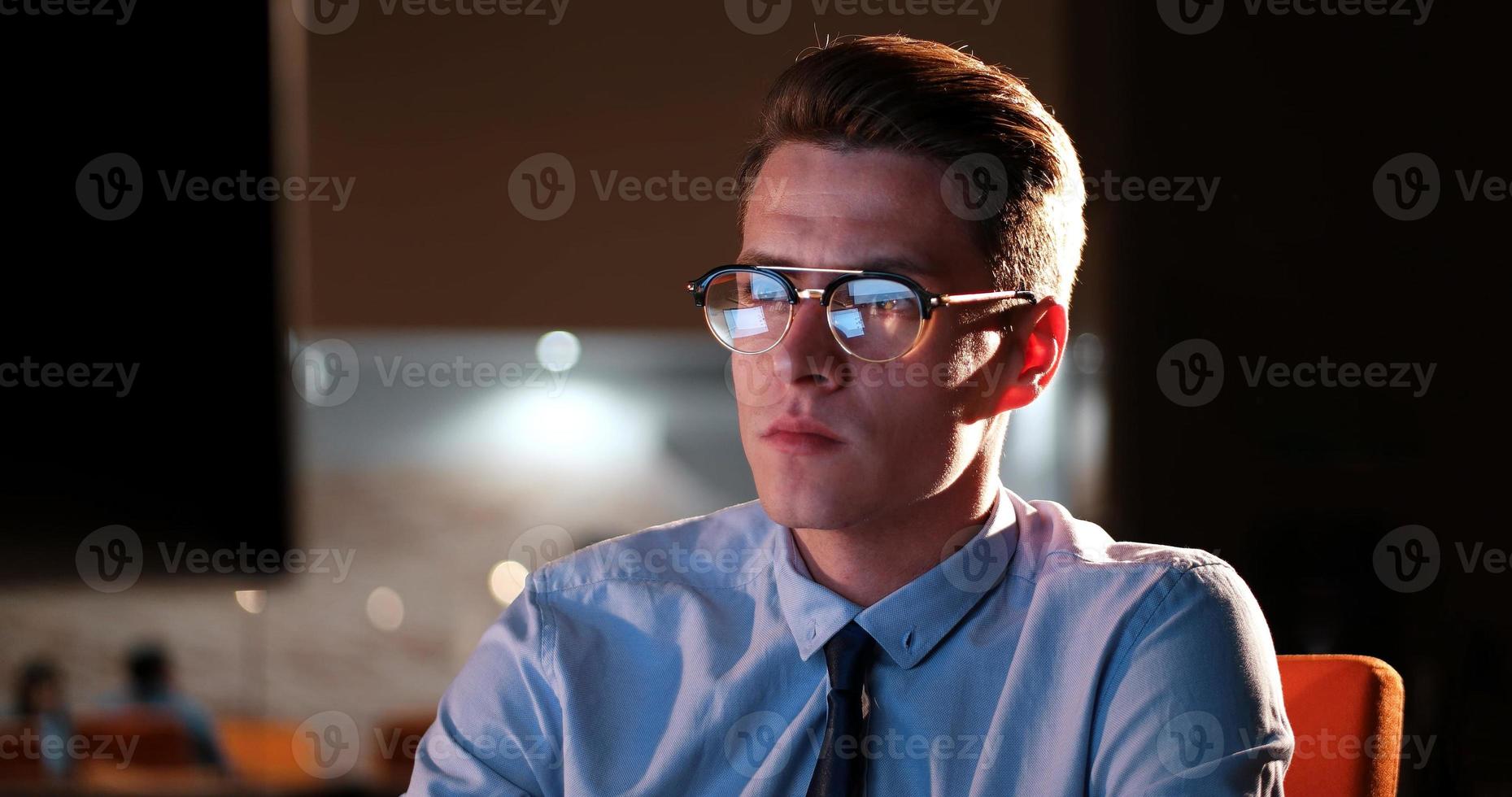 man working on computer in dark office photo
