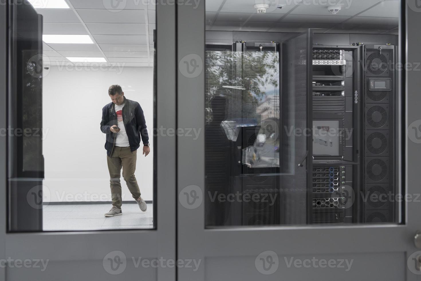 Technicians team updating hardware inspecting system performance in super computer server room or cryptocurrency mining farm. photo