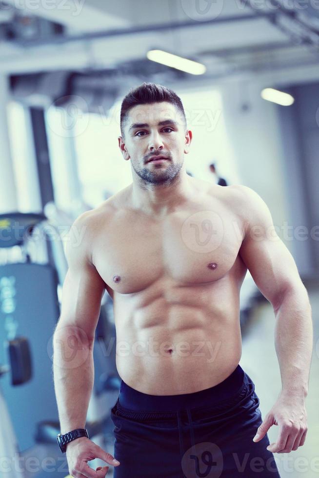 handsome man exercising at the gym photo