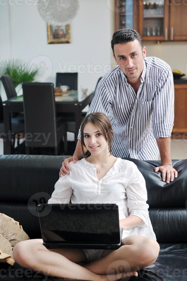 joyful couple relax and work on laptop computer at modern home photo