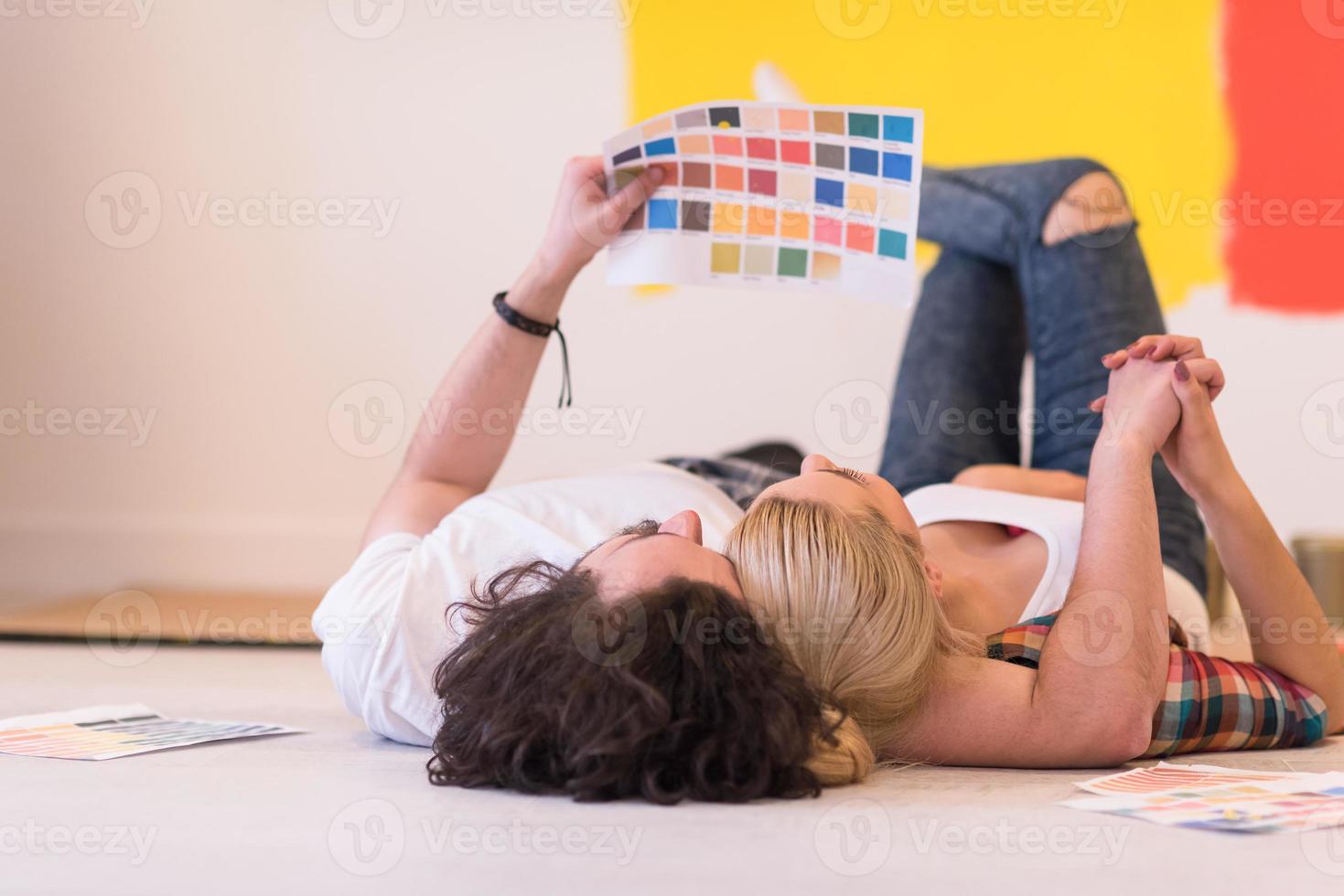 Happy young couple relaxing after painting photo
