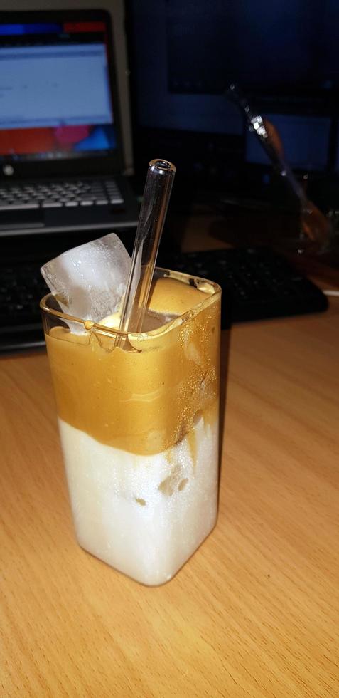 refreshing drink Ice Dalgona Coffee a trendy fluffy frothy creamy whipped coffee served in a korean square glass photo