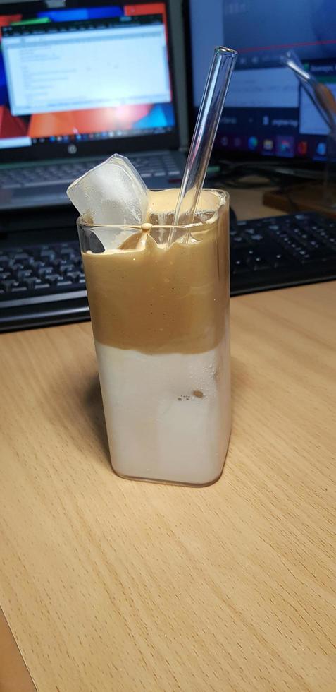 refreshing drink Ice Dalgona Coffee a trendy fluffy frothy creamy whipped coffee served in a korean square glass photo