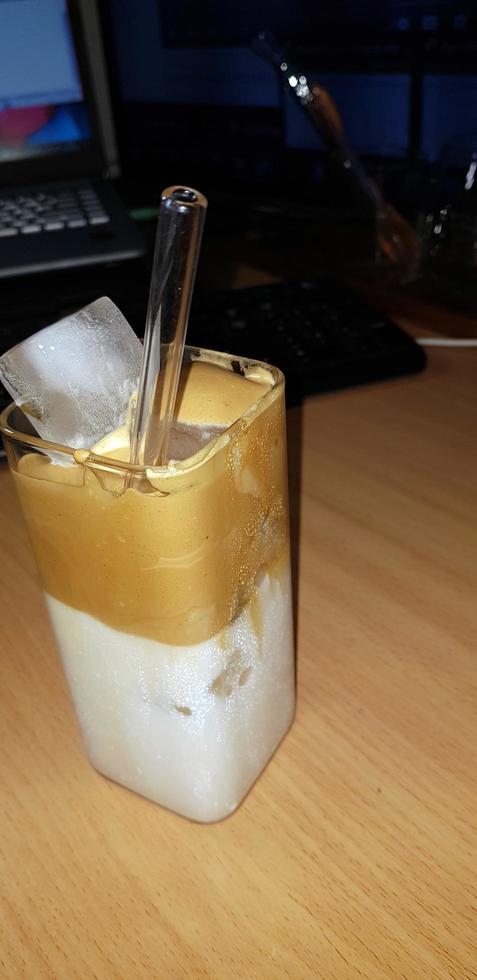 refreshing drink Ice Dalgona Coffee a trendy fluffy frothy creamy whipped coffee served in a korean square glass photo