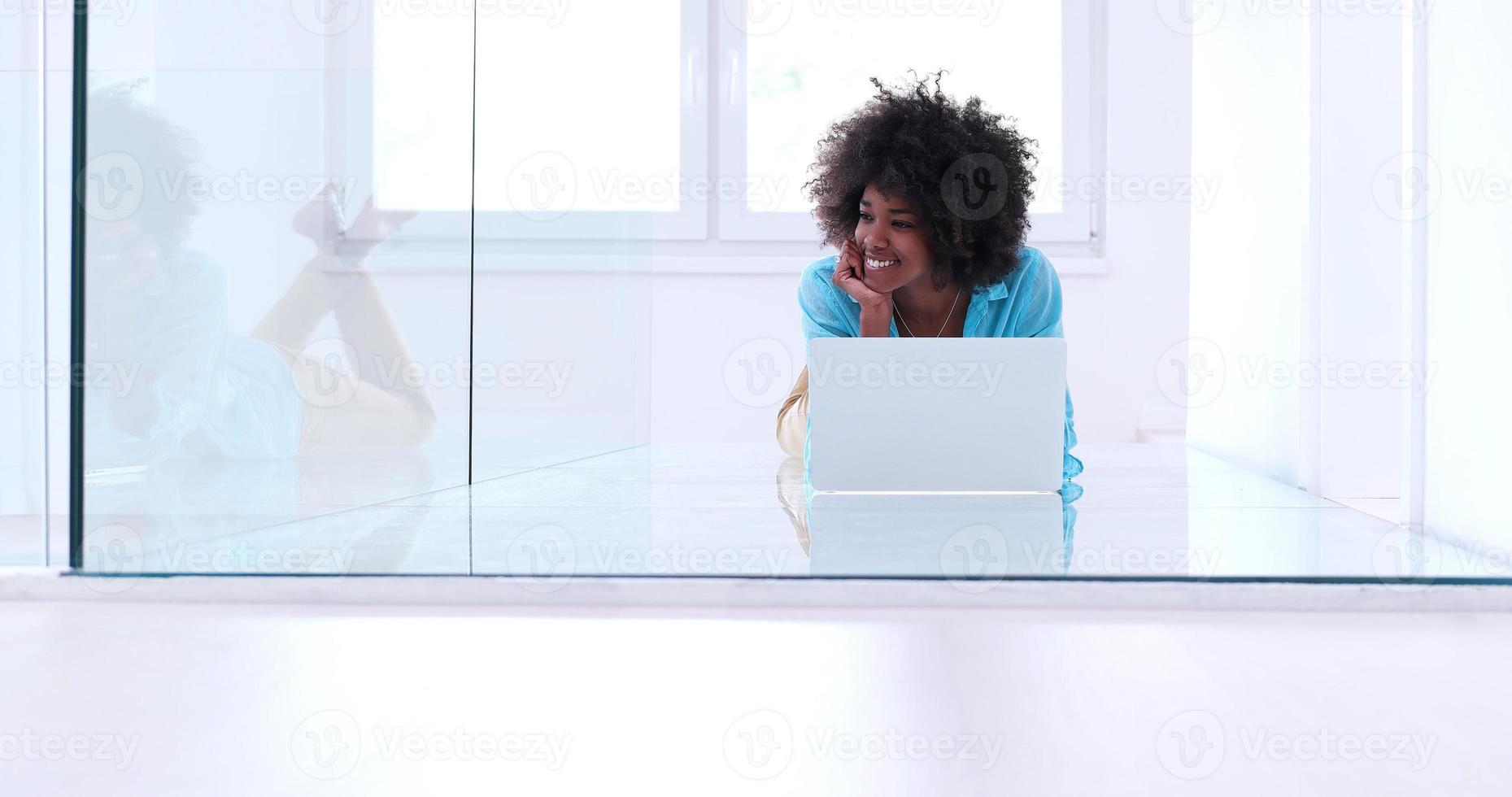 black women using laptop computer on the floor photo