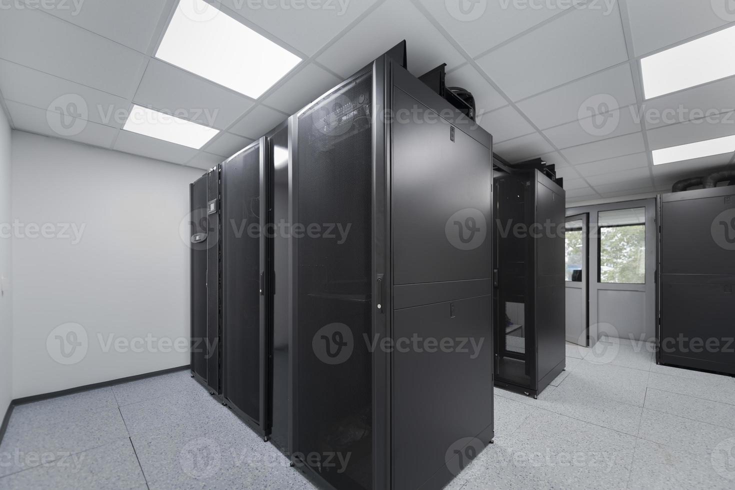 Data Center With Multiple Rows of Fully Operational Server Racks. Modern Telecommunications, Cloud Computing, Artificial Intelligence, Database, Supercomputer Technology Concept. photo