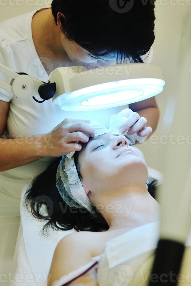 woman with facial mask in cosmetic studio photo