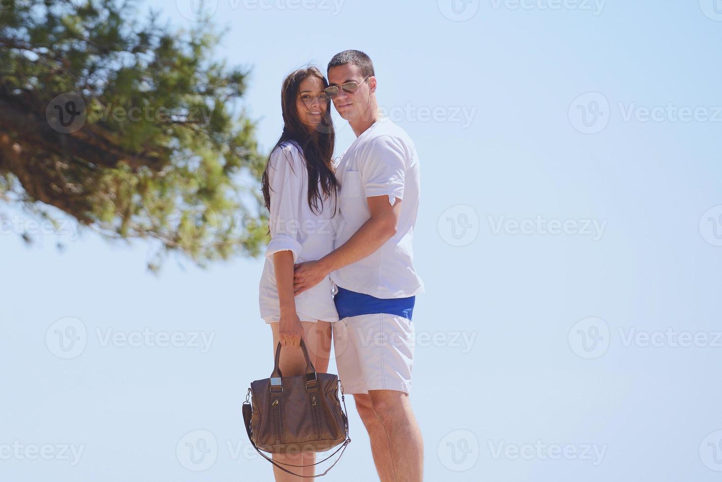 happy couple have fun on the beach photo