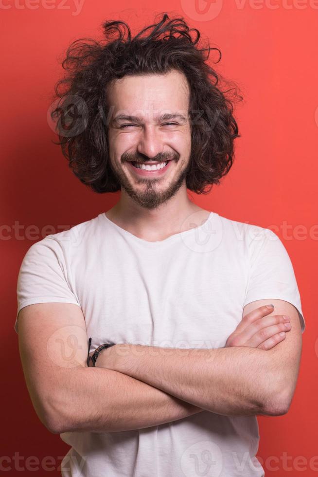 young man with funny hair over color background photo