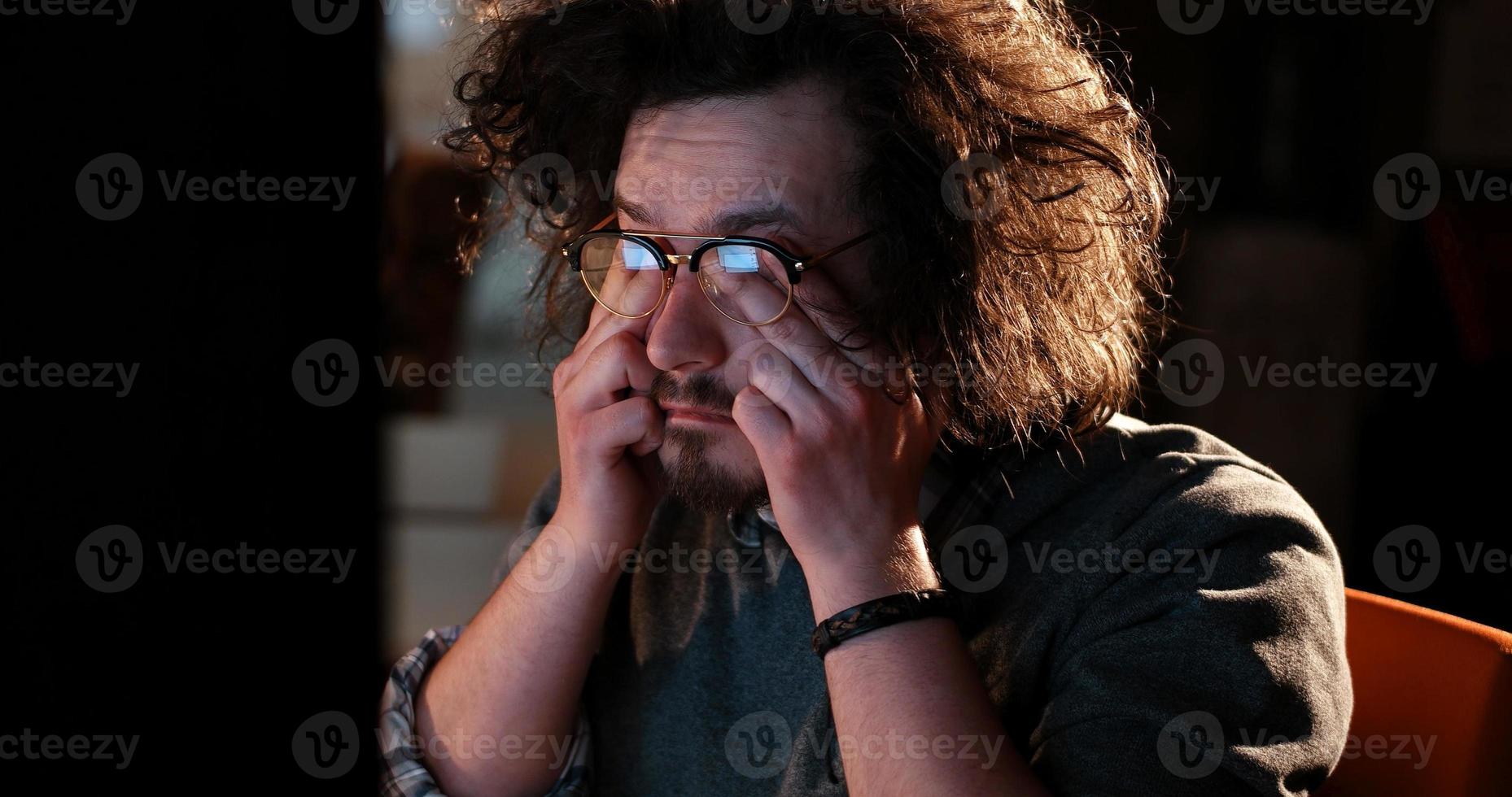 hombre trabajando en una computadora en una oficina oscura foto