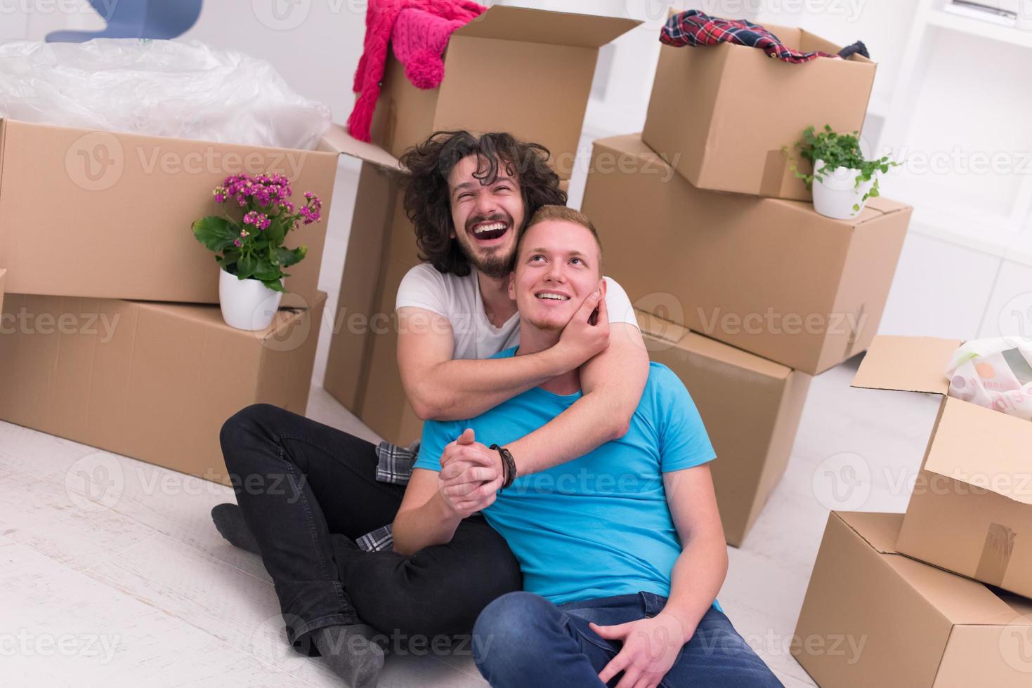 young  gay couple moving  in new house photo