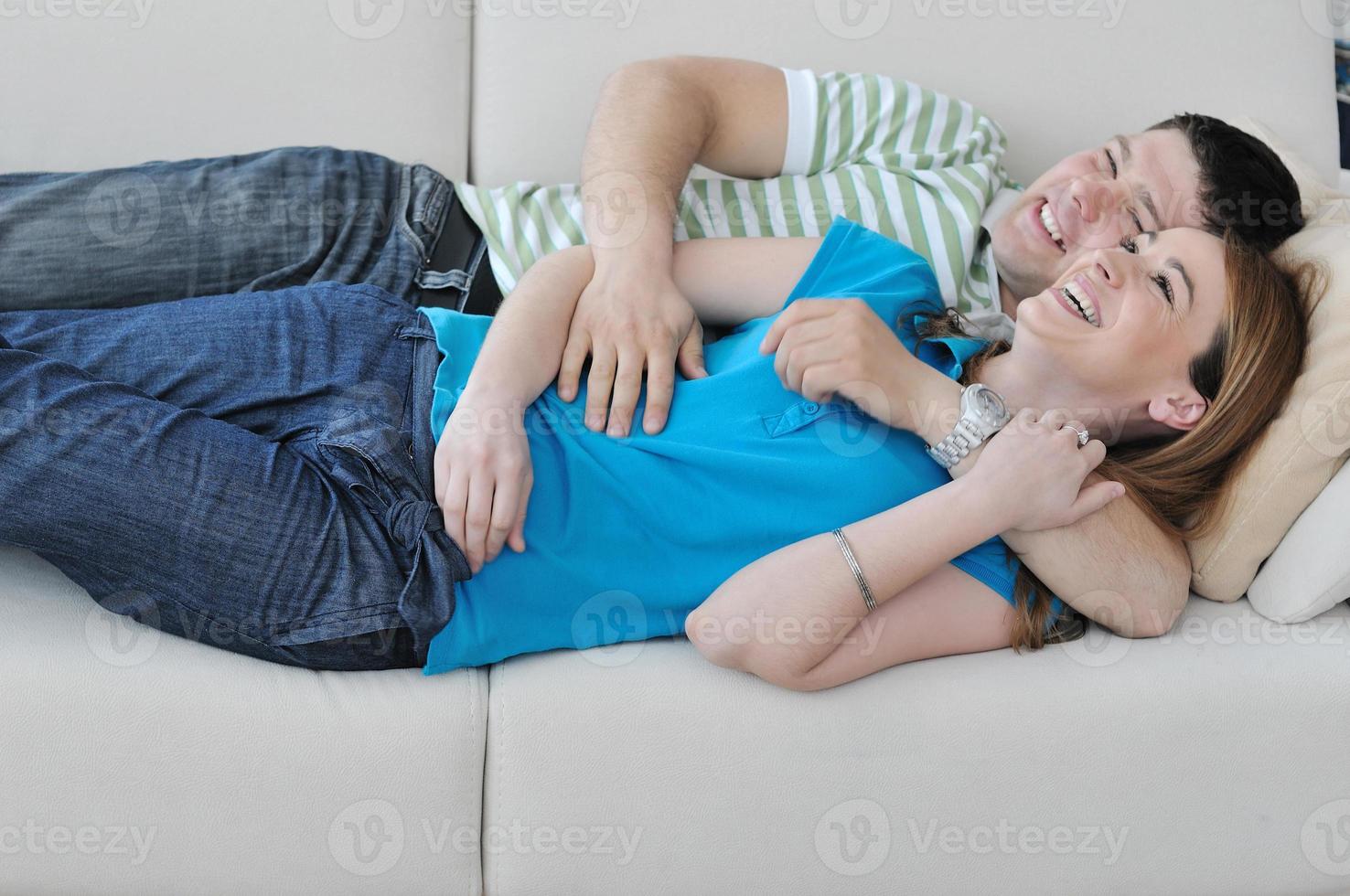 couple relax at home on sofa in living room photo