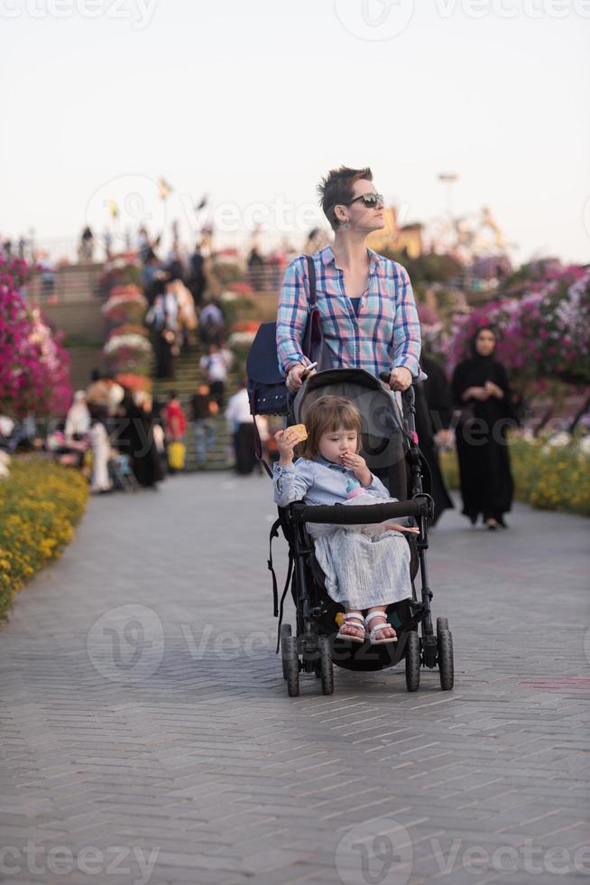 mother and daughter in flower garden photo