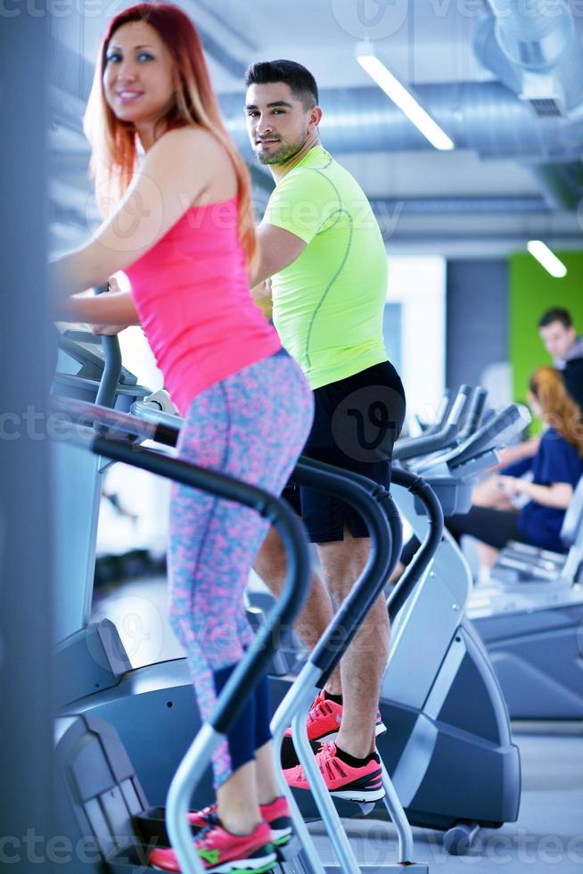 Group of people running on treadmills photo