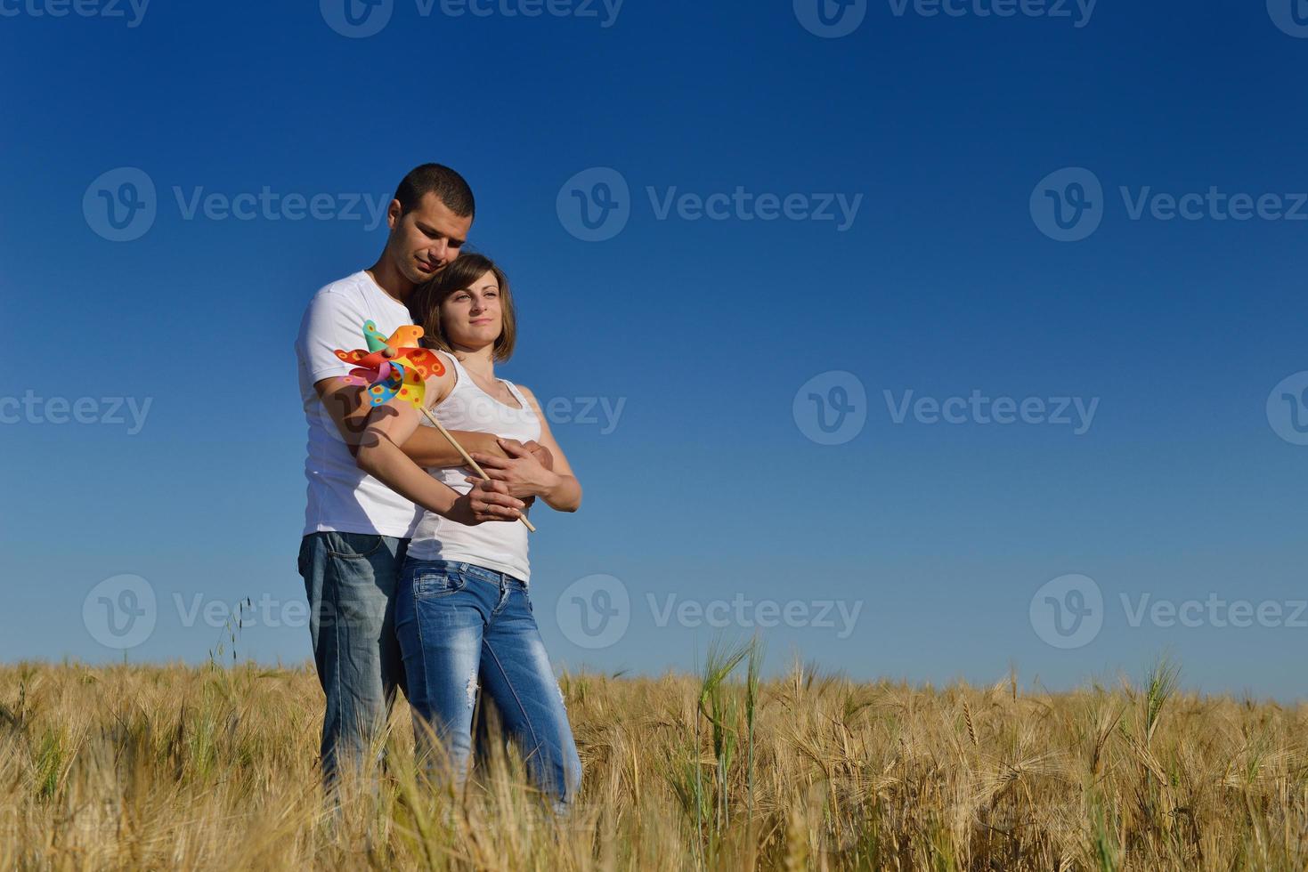 happy couple in wheat field photo