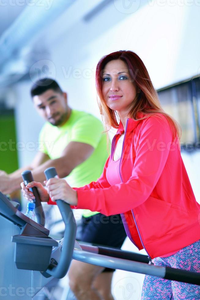 Group of people running on treadmills photo