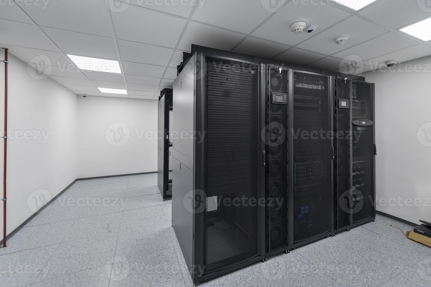 Data Center With Multiple Rows of Fully Operational Server Racks. Modern Telecommunications, Cloud Computing, Artificial Intelligence, Database, Supercomputer Technology Concept. photo