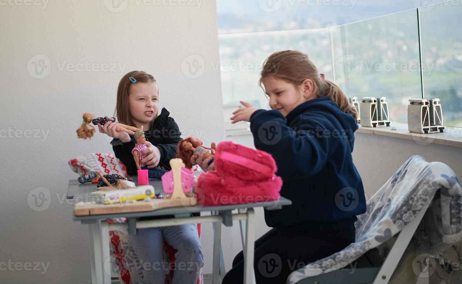 little girls playing with dolls photo