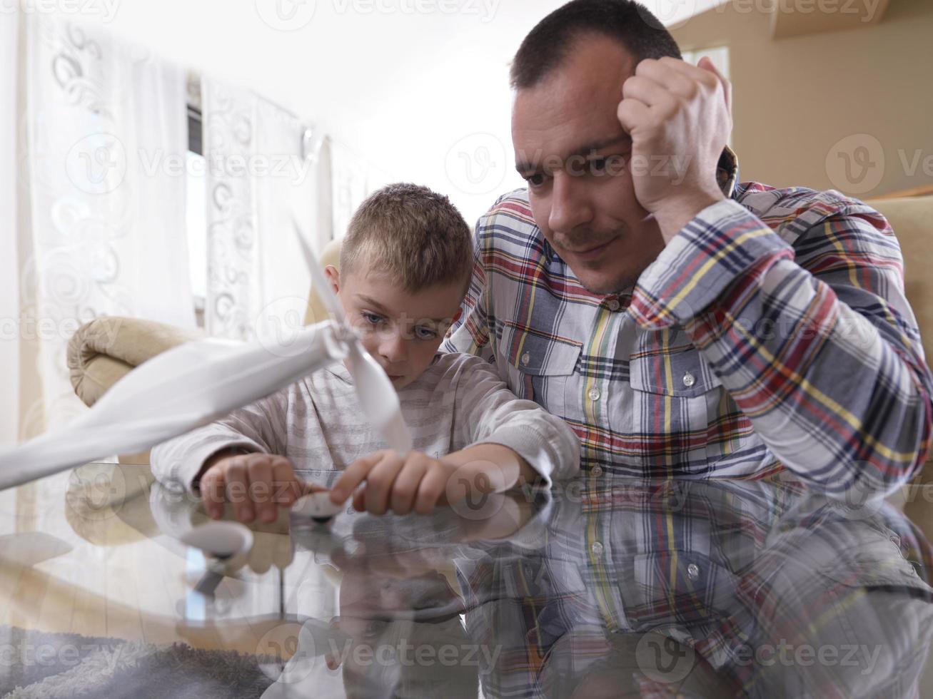 father and son assembling airplane toy photo