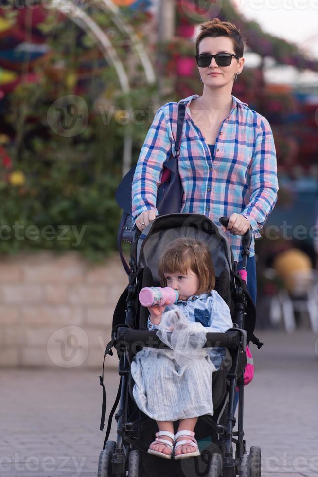 mother and daughter in flower garden photo