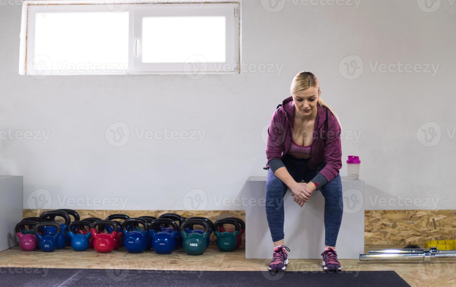 young athlete woman sitting and relaxing photo