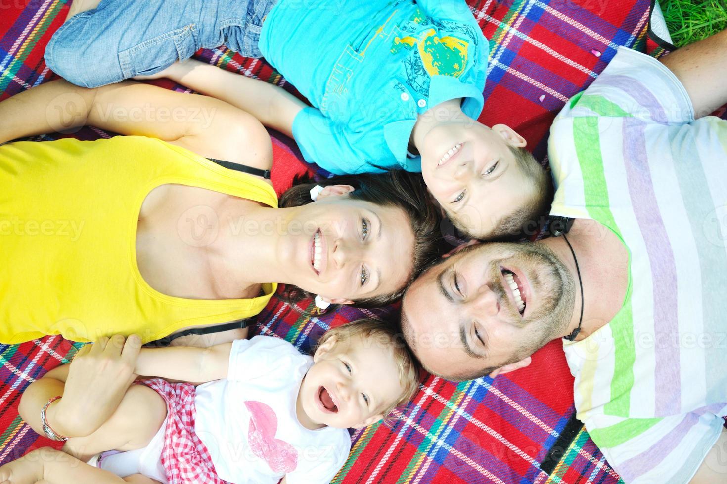 happy young couple with their children have fun at park photo