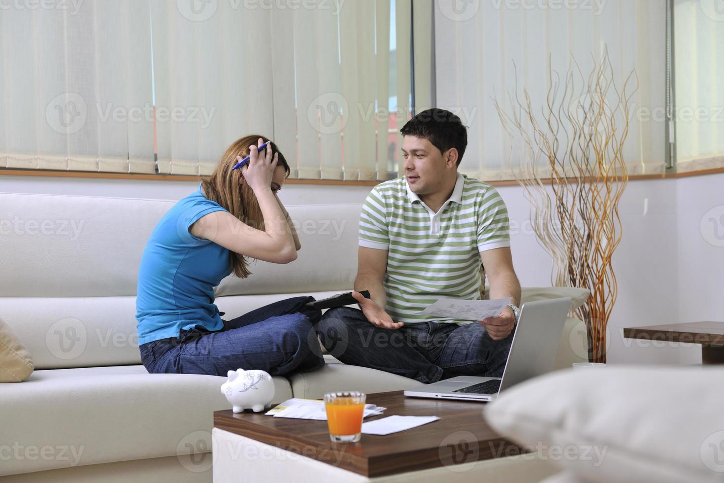 young couple working on laptop at home photo