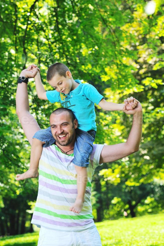 happy father and son have fun at park photo