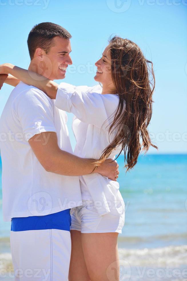 happy couple have fun on the beach photo