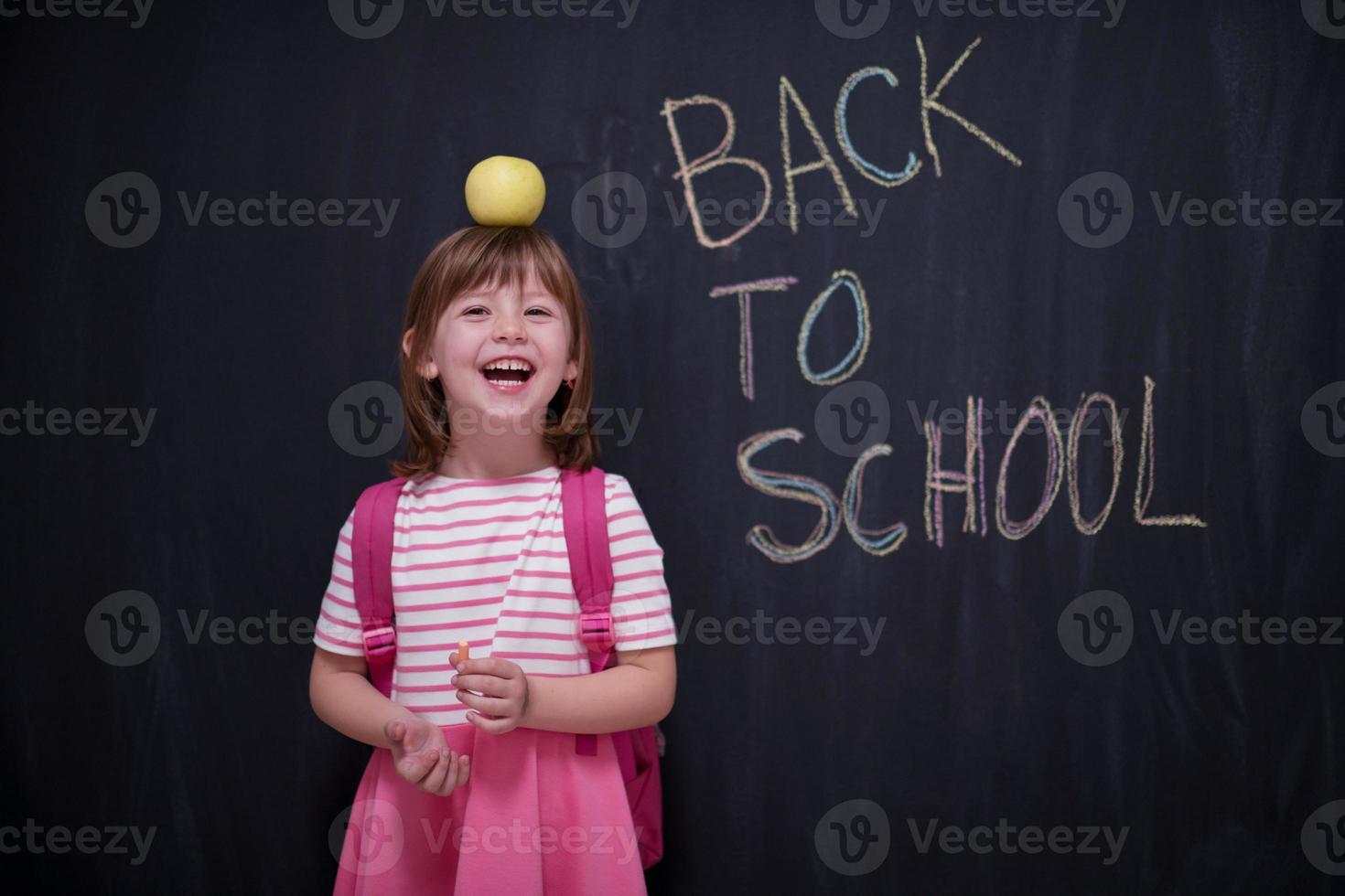 child holding apple on head photo