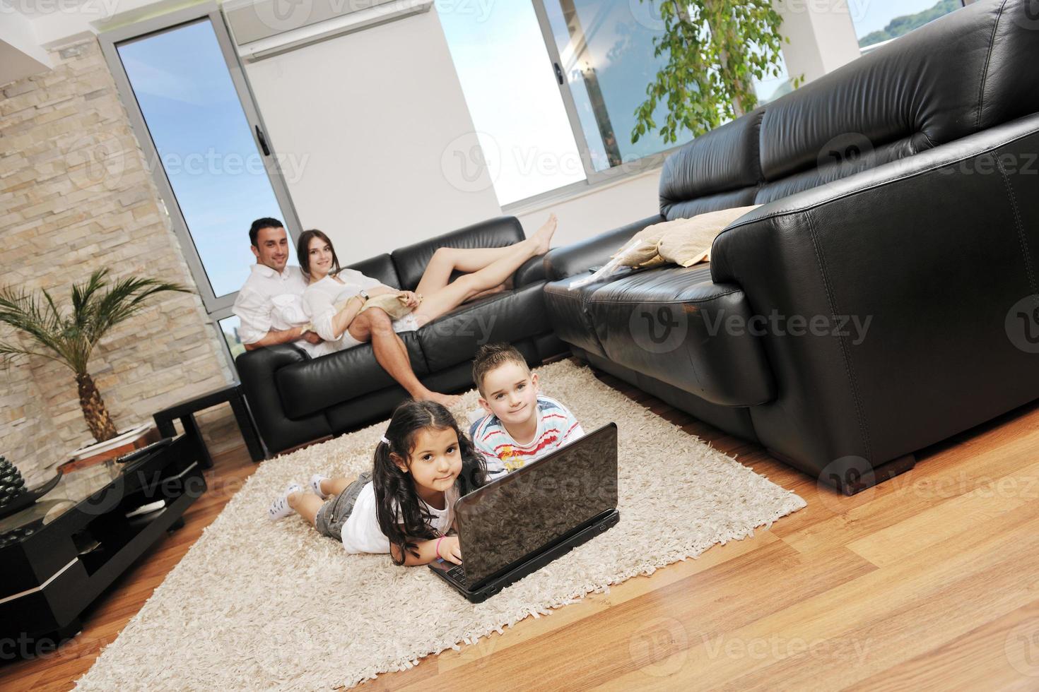 happy young family have fun and working on laptop at home photo