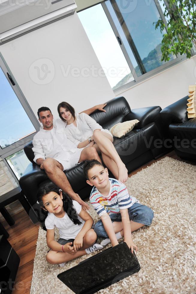 happy young family have fun and working on laptop at home photo