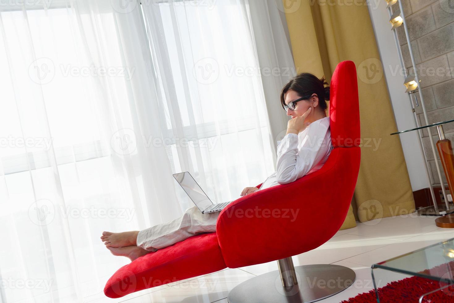 woman using a laptop computer at home photo