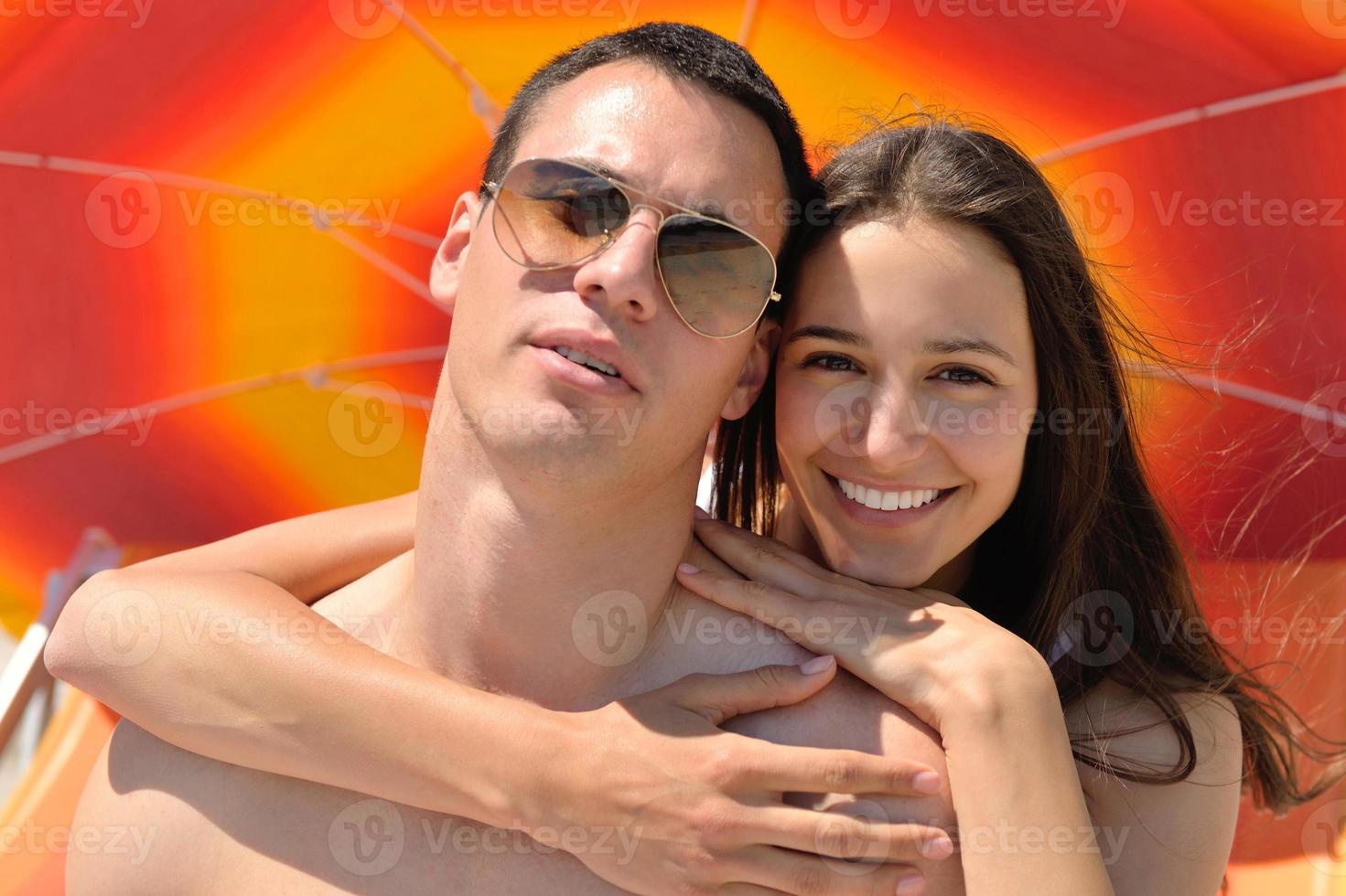 happy young couple have fun on beach photo