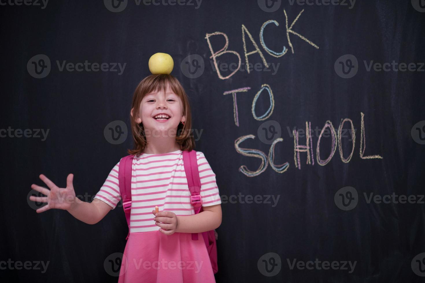 child holding apple on head photo