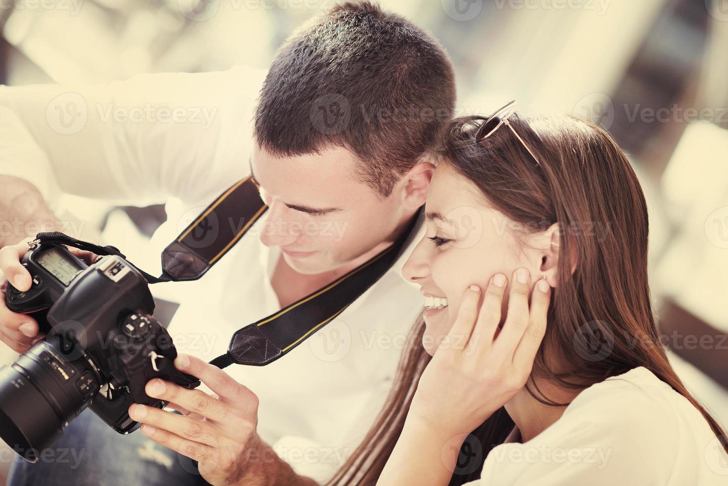 couple looking photos on camera