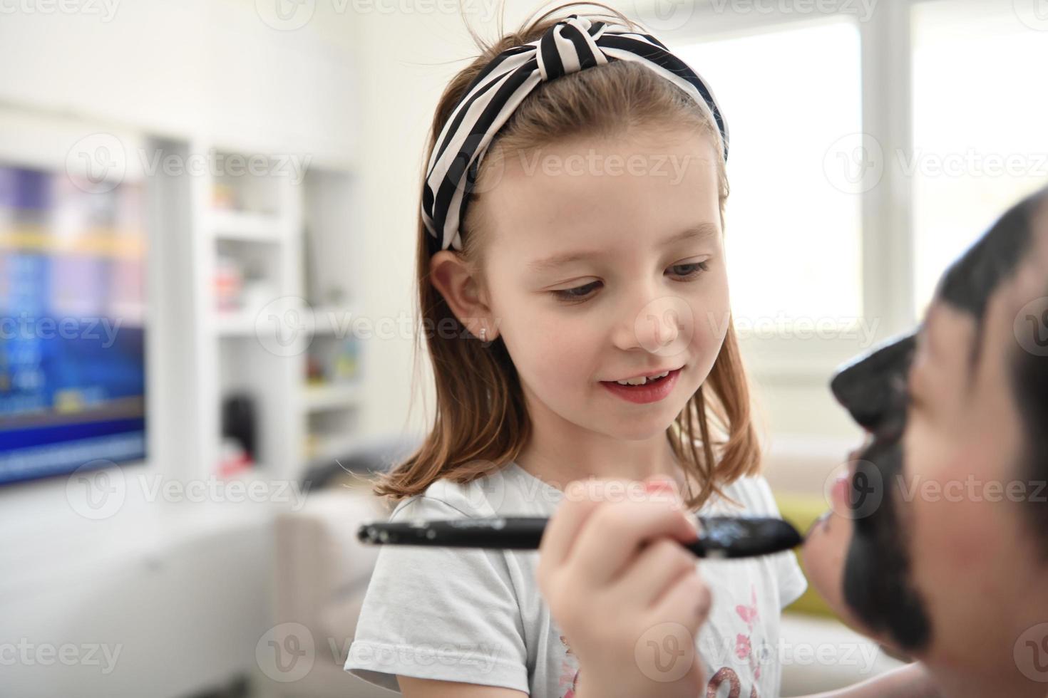 mother and daughter at home making facial mask beauty treatment photo