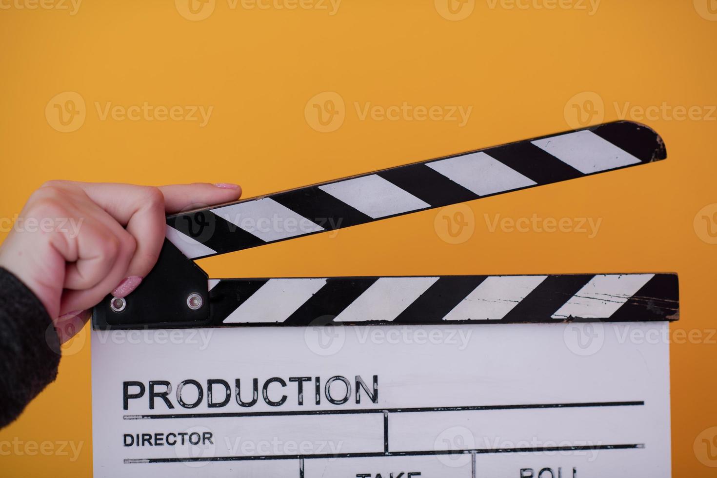 movie clapper on yellow background photo